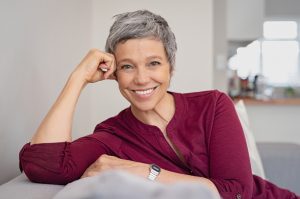 Portrait Of Senior Lady On Couch With Big Smile