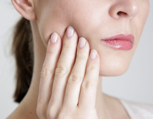 Woman touching her jaw